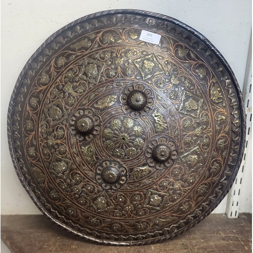 305 - A far eastern embossed copper and brass shield