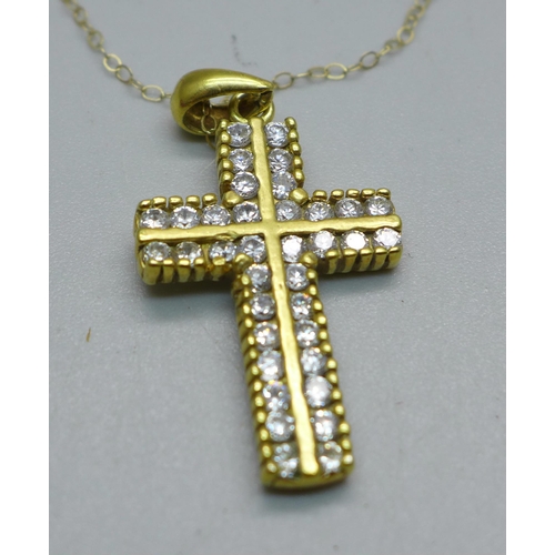 1013 - A yellow metal stone set cross pendant, tests as 9ct gold on a fine 9ct gold chain, 4.9g