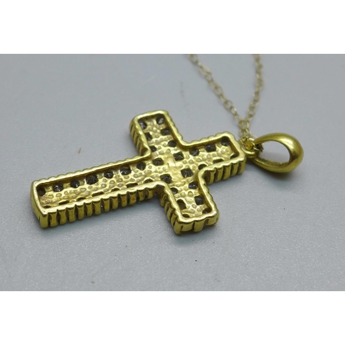 1013 - A yellow metal stone set cross pendant, tests as 9ct gold on a fine 9ct gold chain, 4.9g