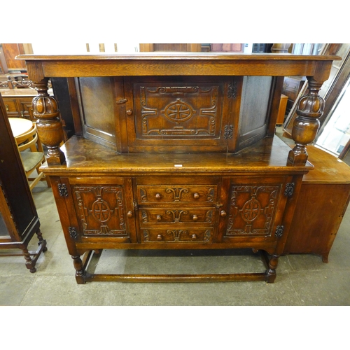 121 - A 17th Century style carved oak court cupboard