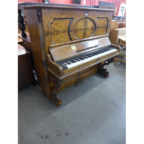 130 - A Victorian burr walnut Pohlmann & Son, Patent Escapement Action overstrung upright piano. With non-... 