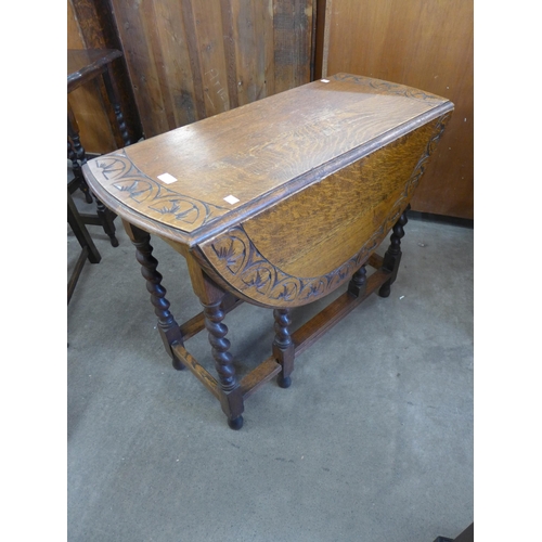 150 - A carved oak barleytwist drop-leaf table