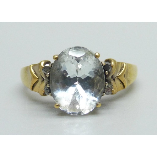 1016 - A silver gilt and rock crystal set ring with diamond shoulders, O