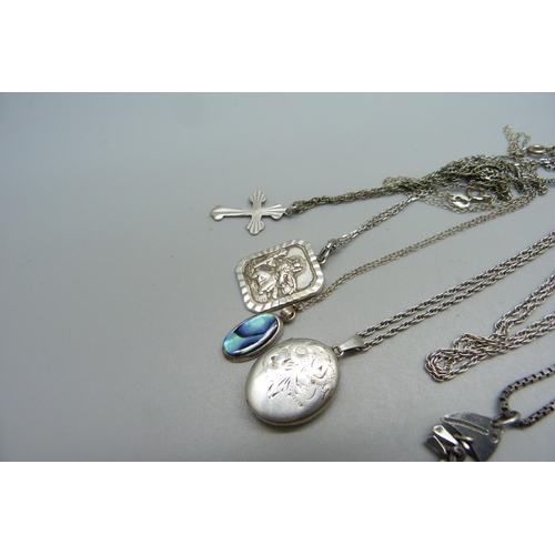 1018 - A silver locket and chain and five silver pendants and chains, 30g