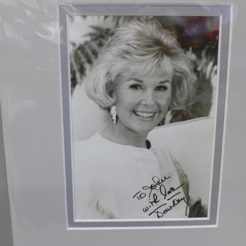 612 - A Doris Day signed photo and signed page, (2)