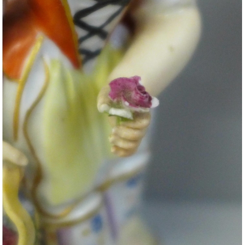 655 - A 19th Century porcelain figure of a girl holding a basket of flowers and an early 19th Century drin... 