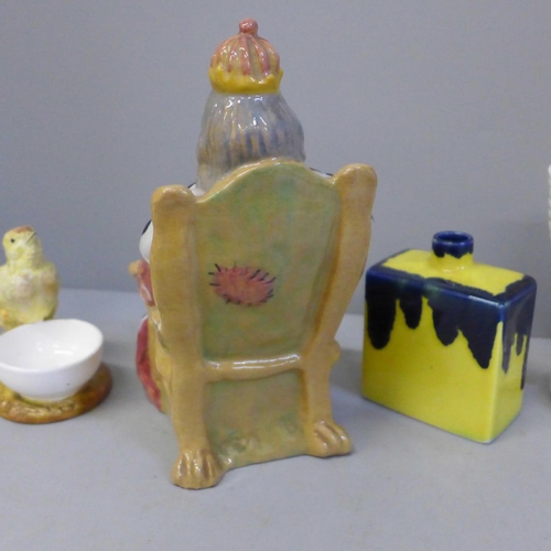 657 - Assorted pottery including a chick egg cup, nautilus shell vase, model of a king on the throne, etc.