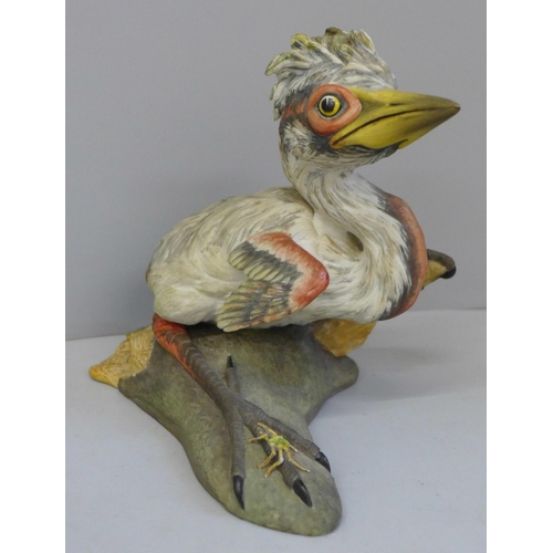 659 - A German pottery figure of a terrier and a Boehm Blue Heron chick with insect