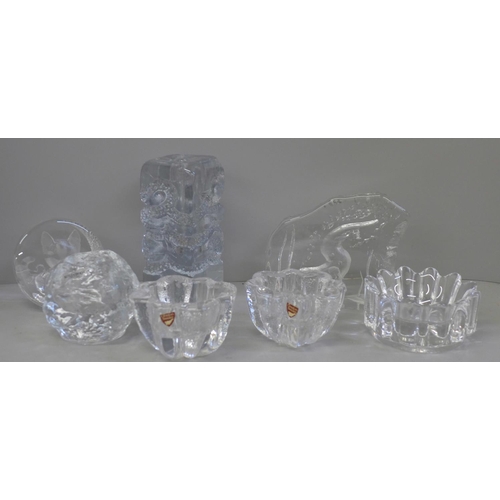 698 - Seven items of clear glass including an Orrefors bowl, Kosta Boda tea light holder and otter paperwe... 