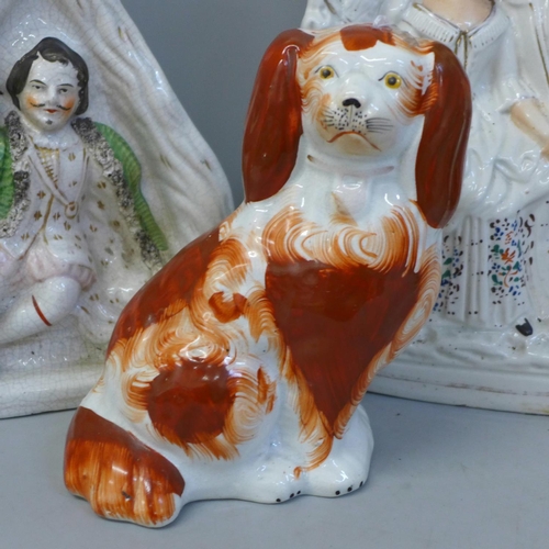 701 - Four Staffordshire flatback figures and a Staffordshire spaniel