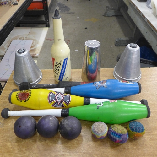 2066 - A box of juggling equipment; fire staff, cups, clubs and balls