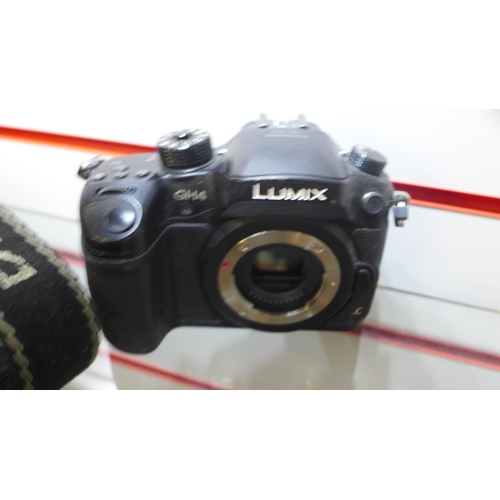 2106 - A camera bundle inc. Lumix and Cannon with lenses and leads