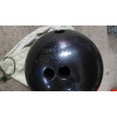 2374 - A ten pin bowling ball with bag and green balls in bag