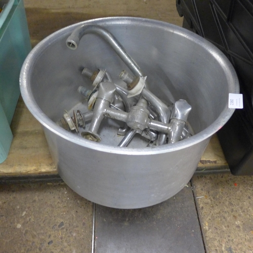 2380 - A large cooking pot and sink taps