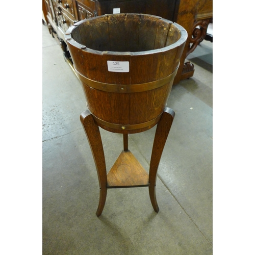 125 - An Edward VII oak and copper bound barrel shaped jardiniere on stand