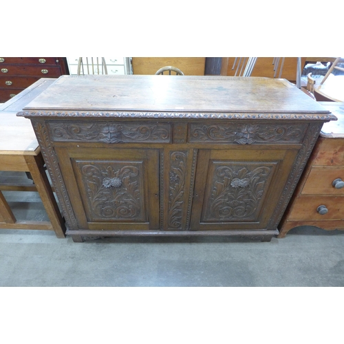 133 - A Victorian carved oak green man dresser