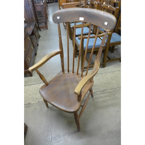 137 - A Victorian elm and beech kitchen elbow chair