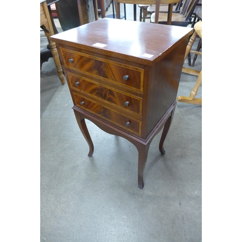 144 - A small Regency style inlaid mahogany three drawer chest