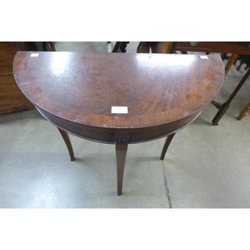 146 - A Regency style mahogany demi lune hall table