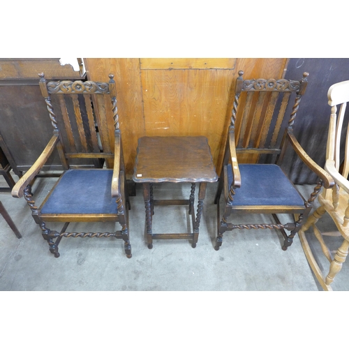 147 - A pair of oak barleytwist elbow chairs and an occasional table