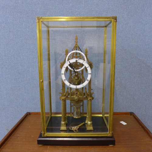 301 - A cased brass fusee skeleton clock