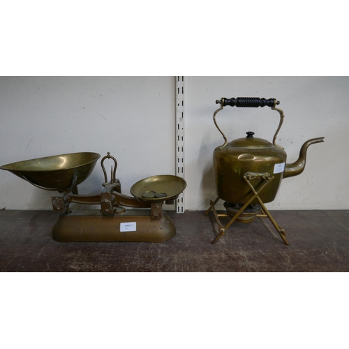 303 - A set of Avery scales with four weights and a brass spirit kettle on stand