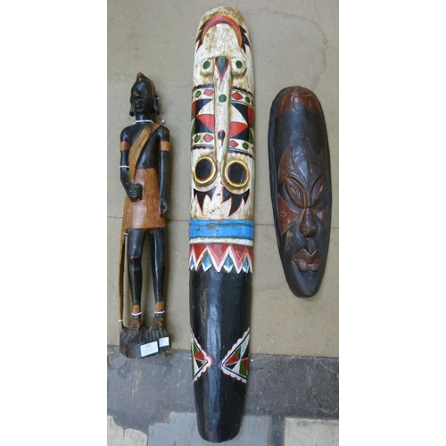 312 - Two African painted wooden face masks and a figure