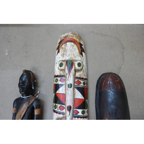 312 - Two African painted wooden face masks and a figure