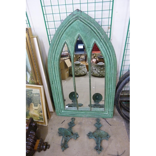 313 - A painted Gothic style mirror and a pair of steel candle sconces