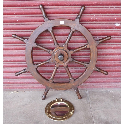 336 - A brass porthole mirror and a stained pine ships wheel