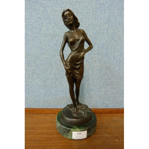 348 - A French stye bronze figure of a lady in negligee, on green marble socle