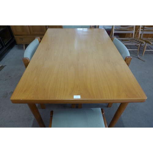 7 - A Danish A.B.J. teak extending dining table and five chairs