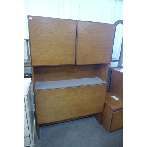 81B - A teak lowboard, a teak wall unit one other lowboard