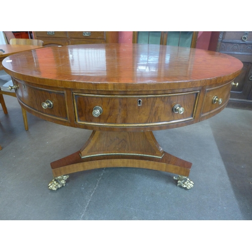 96 - A Regency style simulated rosewood drum shaped four drawer library table