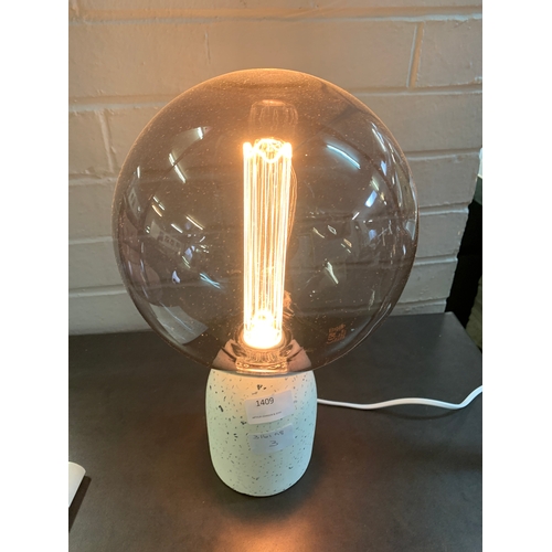 1409 - A terrazzo base table lamp with a large smoked glass anti-glare bulb featuring a decorative internal... 