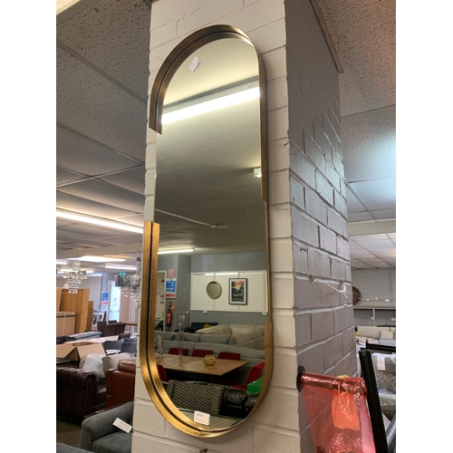 1410 - A gold pill shaped mirror