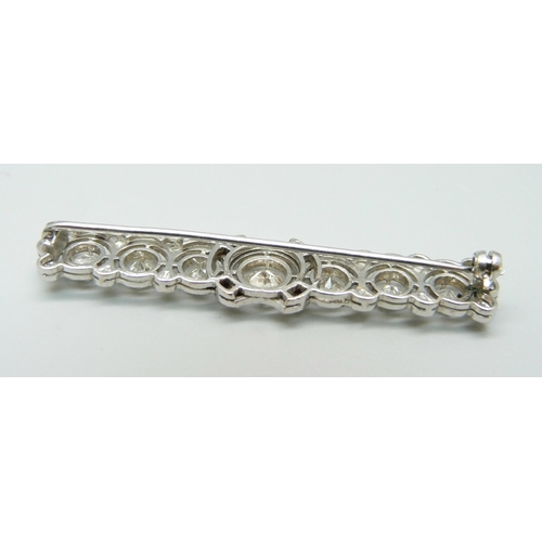 1025 - A white metal and diamond set brooch, centre stone approximately 0.5ct, six other diamonds approxima... 