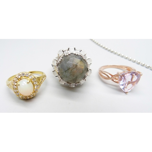 1028 - A silver and mother of pearl pendant and chain, and three dress rings, one set with synthetic opal, ... 