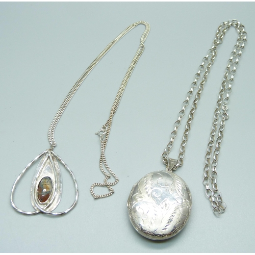 1040 - A silver Arts and Crafts pendant and chain and a silver locket and chain