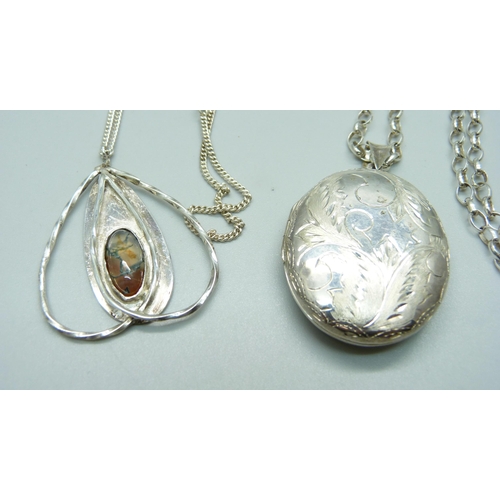 1040 - A silver Arts and Crafts pendant and chain and a silver locket and chain