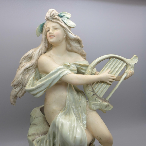 602 - A Royal Dux figure of a girl playing a harp, 26.5cm