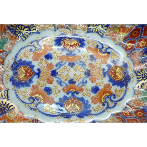 605 - A Japanese porcelain oval Imari bowl with scallop edge, four character mark to base, 26cm  a/f