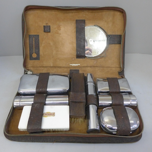 665 - A Crown Bros. of Leicester grooming kit in a reptile skin case