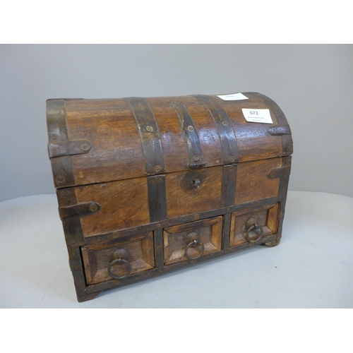 672 - A metal bound wooden casket with contents including jewellery, etc.