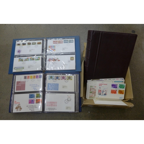 695 - Stamps; a box of GB first day covers in three albums and loose