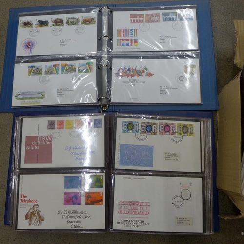 695 - Stamps; a box of GB first day covers in three albums and loose