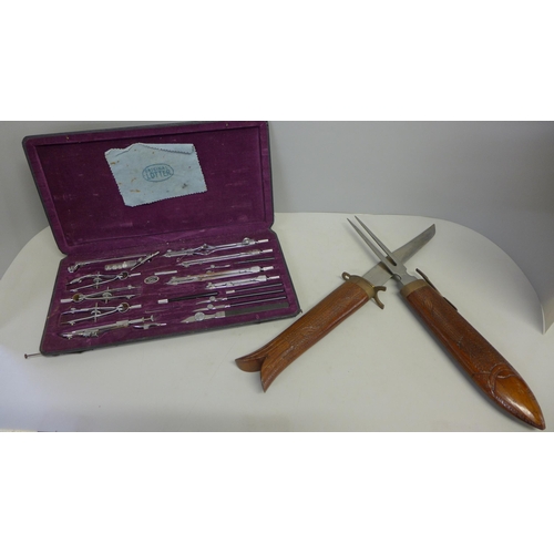 732 - A cased draughtsman's set and a wooden fish carving set