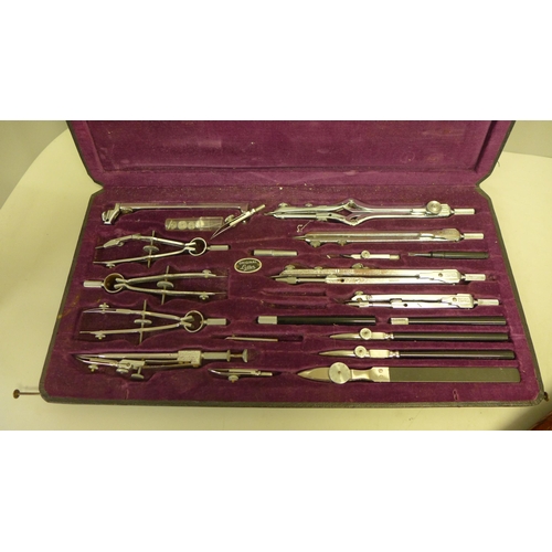 732 - A cased draughtsman's set and a wooden fish carving set