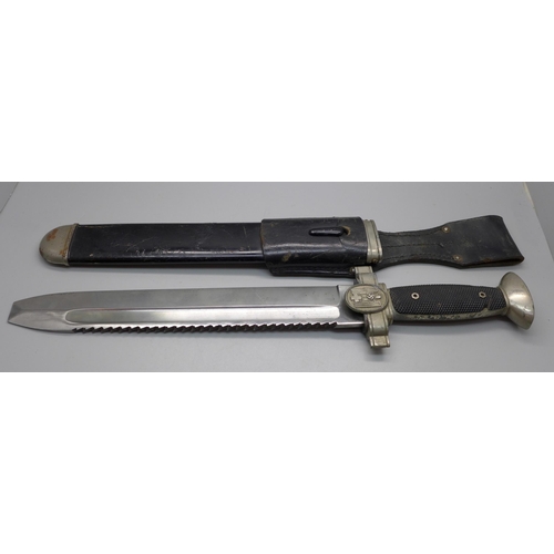 799 - A German WWII period saw blade knife/dagger, with scabbard, the leather stamped Carl-Busse 1940