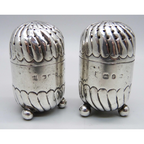 812 - A pair of Victorian silver peppers, Birmingham and London marks, 38g